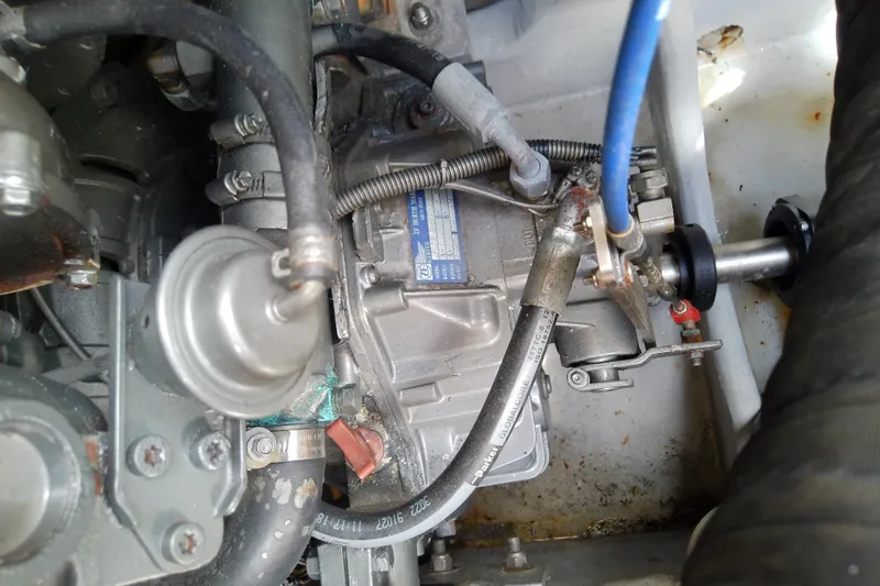 Dolce Far Niente Yacht Photos Pics Engine components of a 2004 Mainship 34 Pilot II boat, featuring hoses and metal parts.