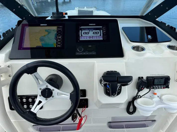  Yacht Photos Pics 2022 Brig Eagle 10 boat dashboard with steering wheel, navigation screens, and controls.