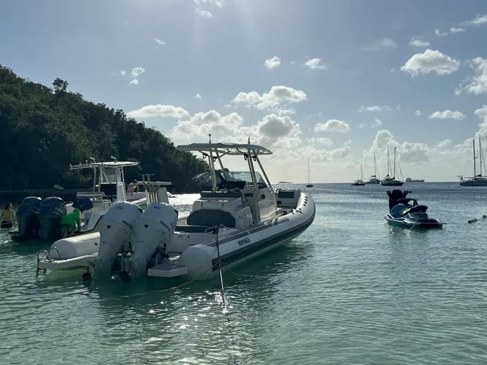  Yacht Photos Pics 2022 Brig Eagle 10 boat anchored in a serene tropical bay with other boats.