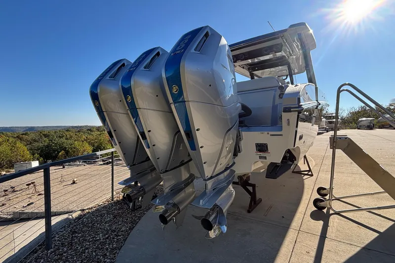  Yacht Photos Pics 2024 Fountain 38 SCX boat with triple outboard engines under a clear blue sky.