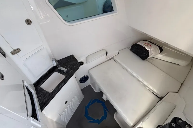  Yacht Photos Pics 2024 Fountain 38 SCX cabin interior with sink and cushioned seating.