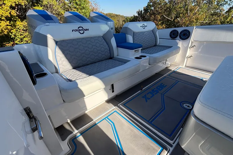  Yacht Photos Pics 2024 Fountain 38 SCX boat interior with cushioned seating and stylish flooring.