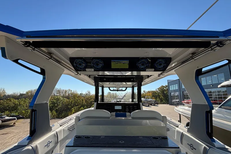  Yacht Photos Pics 2024 Fountain 38 SCX boat interior with modern dashboard and seating, under clear blue sky.