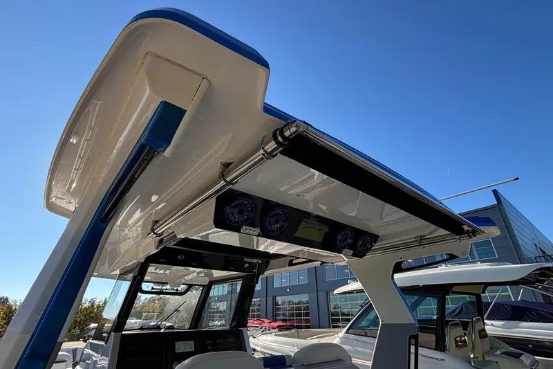  Yacht Photos Pics 2024 Fountain 38 SCX boat with advanced audio system and sleek design under clear blue sky.