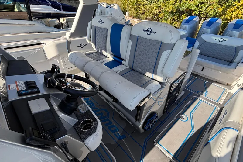  Yacht Photos Pics 2024 Fountain 38 SCX boat interior with luxury seating and modern steering console.