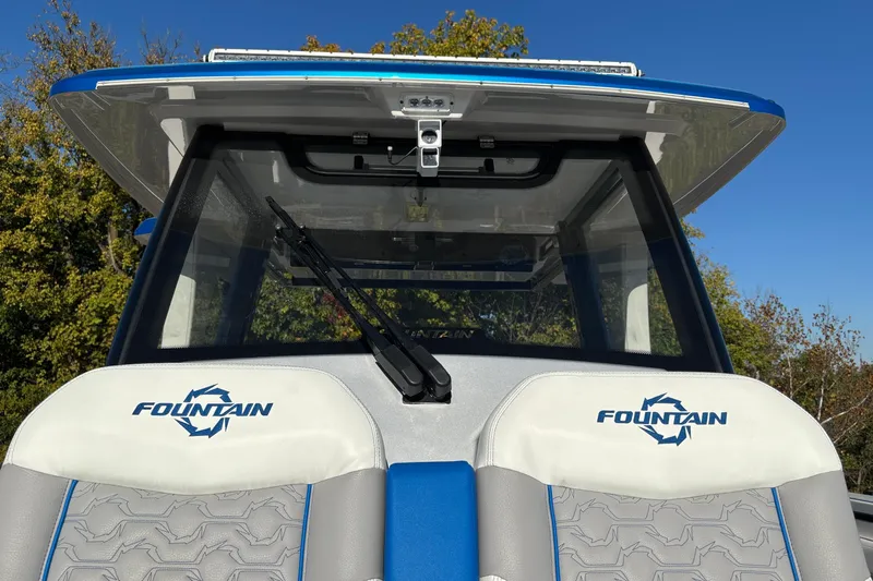  Yacht Photos Pics 2024 Fountain 38 SCX boat with branded seats and windshield, under clear blue sky.