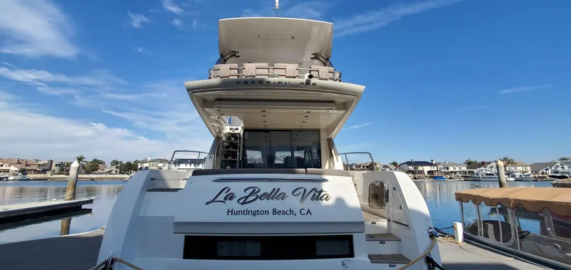 " La Bella Vita" Yacht Photos Pics Prestige 560 Flybridge yacht, 2017 model, docked at Huntington Beach, CA, under clear blue skies.