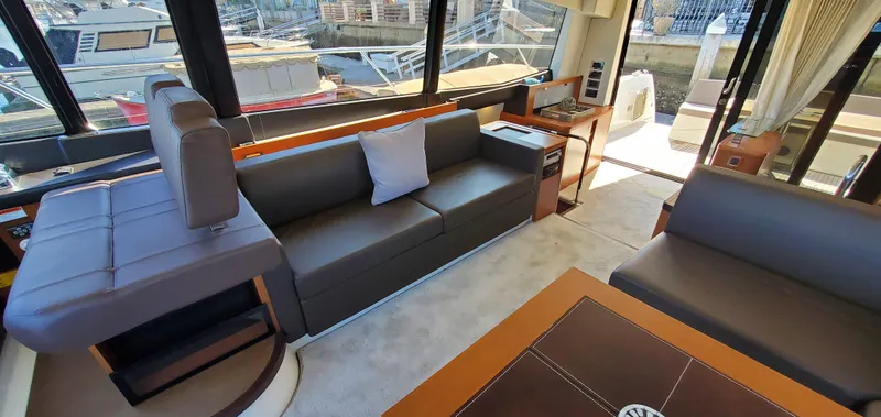 " La Bella Vita" Yacht Photos Pics Luxurious interior of a 2017 Prestige 560 Flybridge yacht with modern seating and large windows.