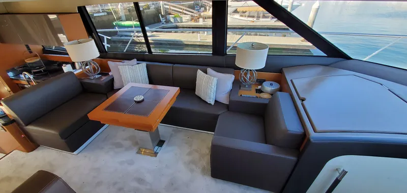" La Bella Vita" Yacht Photos Pics Luxurious interior of 2017 Prestige 560 Flybridge yacht with elegant seating and table.