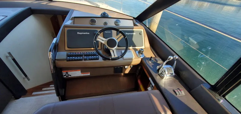 " La Bella Vita" Yacht Photos Pics Helm of 2017 Prestige 560 Flybridge yacht with steering wheel and control panel.