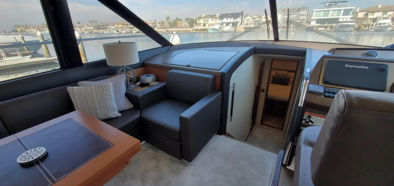 " La Bella Vita" Yacht Photos Pics Luxurious interior of 2017 Prestige 560 Flybridge yacht with modern seating and navigation equipment.