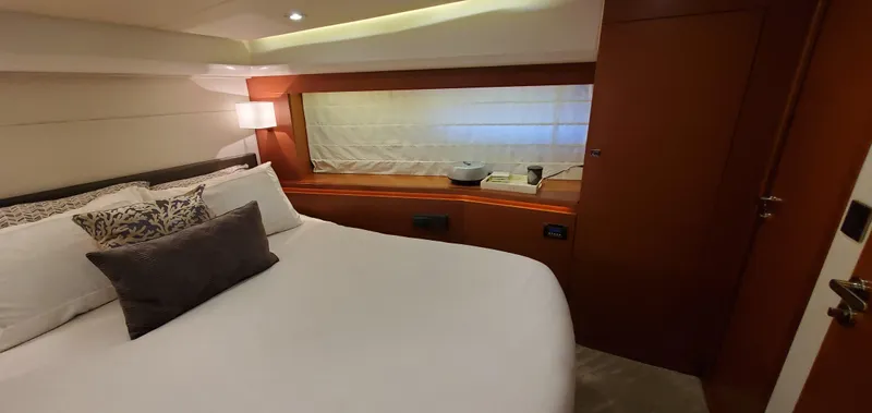 " La Bella Vita" Yacht Photos Pics Luxurious bedroom interior of 2017 Prestige 560 Flybridge yacht with elegant bedding and wood accents.