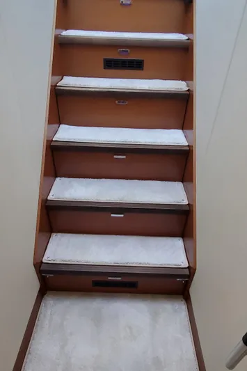 " La Bella Vita" Yacht Photos Pics Staircase inside 2017 Prestige 560 Flybridge yacht with carpeted steps.