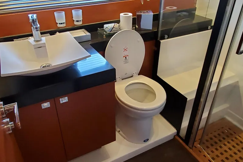 " La Bella Vita" Yacht Photos Pics Bathroom interior of 2017 Prestige 560 Flybridge yacht, featuring sink and toilet.