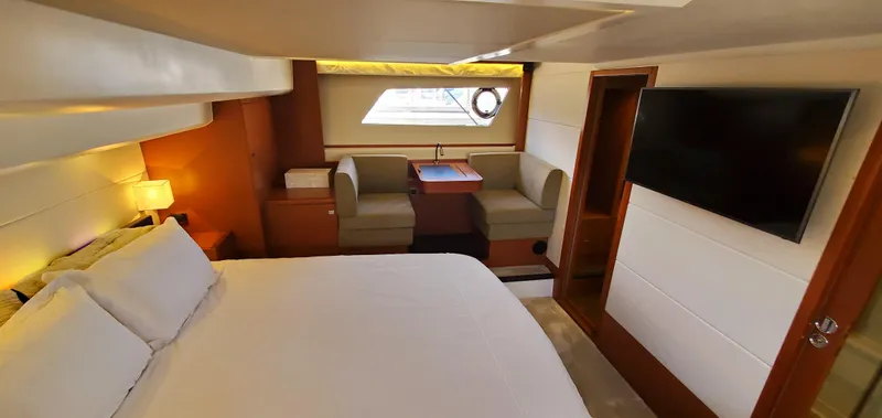 " La Bella Vita" Yacht Photos Pics Luxurious cabin interior of 2017 Prestige 560 Flybridge yacht with bed and seating area.
