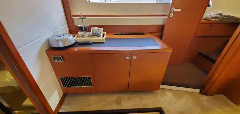 " La Bella Vita" Yacht Photos Pics Interior of a 2017 Prestige 560 Flybridge yacht, featuring a sleek wooden cabinet.