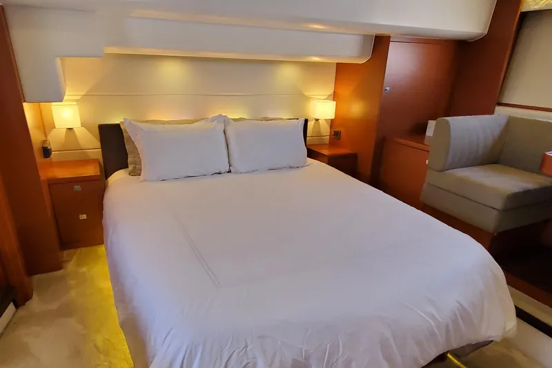 " La Bella Vita" Yacht Photos Pics Luxurious bedroom interior of 2017 Prestige 560 Flybridge yacht with elegant lighting and cozy bedding.