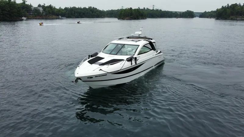  Yacht Photos Pics 2016 Cobalt A40 boat cruising on a serene lake with distant trees.