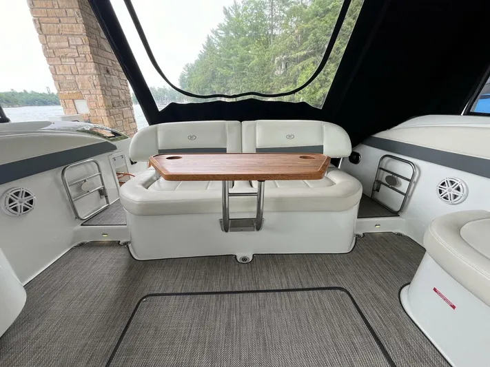 Yacht Photos Pics Interior of 2016 Cobalt A40 boat with cushioned seating and wooden table.