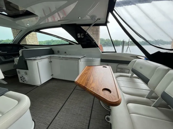  Yacht Photos Pics Interior of a 2016 Cobalt A40 boat with modern seating and wooden table.