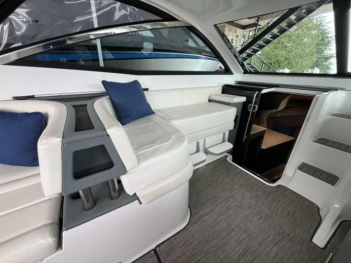  Yacht Photos Pics Interior of a 2016 Cobalt A40 boat with white seating and blue cushions.