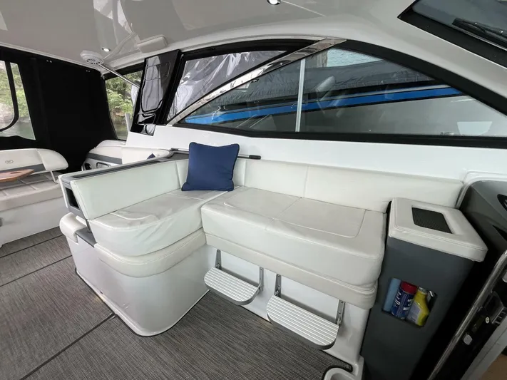  Yacht Photos Pics 2016 Cobalt A40 interior with white seating and a blue cushion.