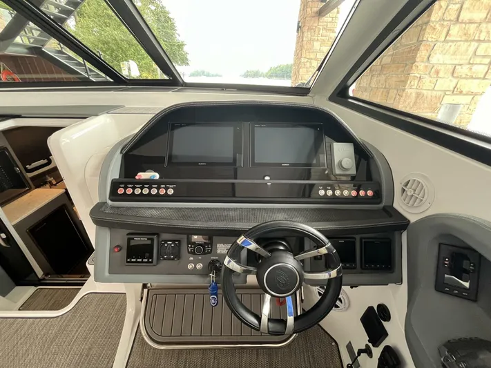  Yacht Photos Pics Helm of 2016 Cobalt A40 boat with modern controls and steering wheel.