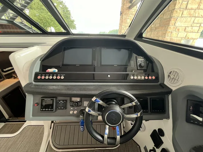  Yacht Photos Pics Helm of 2016 Cobalt A40 boat with modern controls and steering wheel.