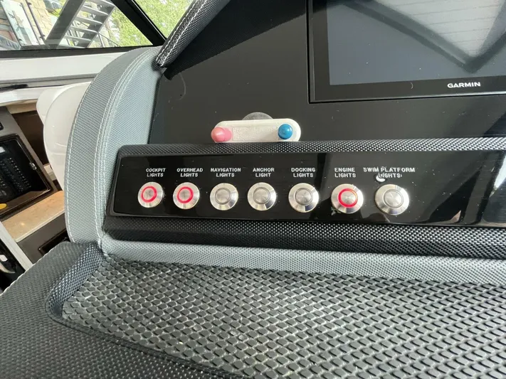  Yacht Photos Pics Control panel of a 2016 Cobalt A40 boat with labeled light switches.
