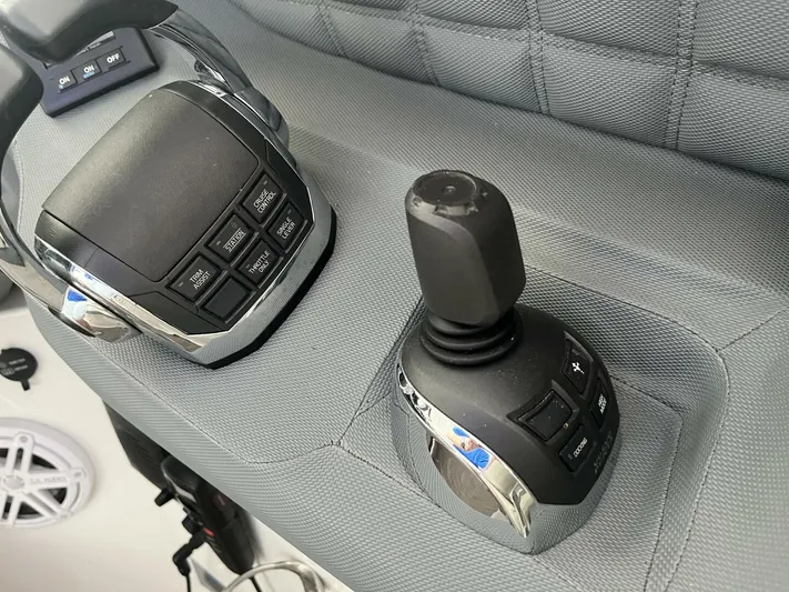  Yacht Photos Pics Control panel of a 2016 Cobalt A40 boat with joystick and buttons.
