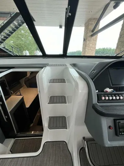  Yacht Photos Pics Interior view of 2016 Cobalt A40 boat cockpit with modern controls and steps.