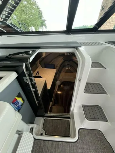  Yacht Photos Pics Interior view of a 2016 Cobalt A40 boat cabin with steps and seating area.