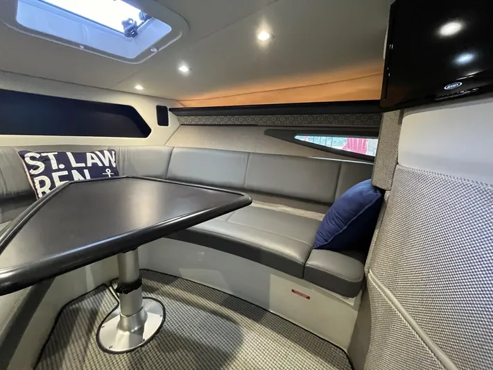  Yacht Photos Pics Interior of a 2016 Cobalt A40 boat with a cozy seating area and table.