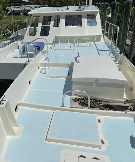 Mirage Yacht Photos Pics Custom 1996 model 62 boat with spacious deck and cabin, docked at marina.