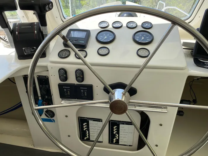 Mirage Yacht Photos Pics Boat steering wheel and control panel with gauges, Custom 62 model, 1996.
