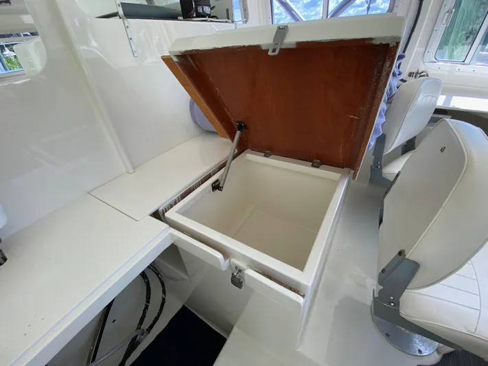 Mirage Yacht Photos Pics Open storage compartment on a 1996 Custom 62 boat interior.