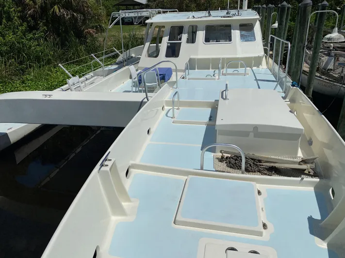 Mirage Yacht Photos Pics Custom 62 boat from 1996 docked, featuring spacious deck and cabin area.