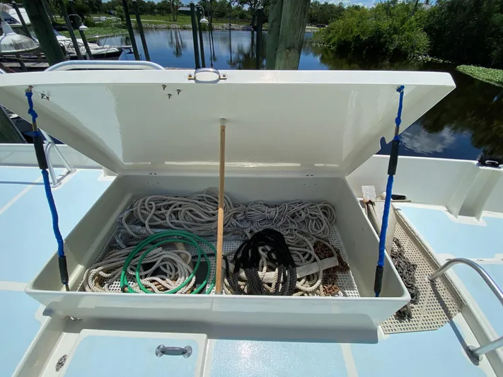Mirage Yacht Photos Pics Open storage compartment on a 1996 Custom 62 boat, containing ropes and equipment.