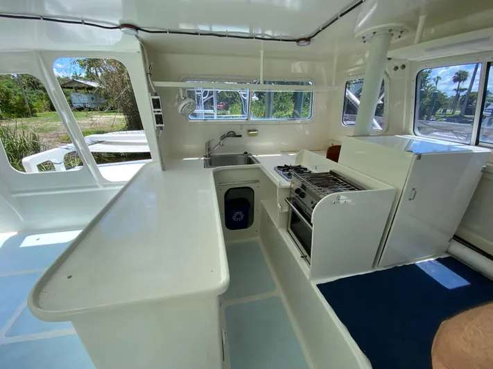 Mirage Yacht Photos Pics Interior of a 1996 Custom 62 boat with kitchen and appliances.