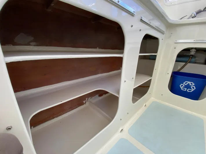 Mirage Yacht Photos Pics Interior shelves of a 1996 Custom model 62 boat with a recycling bin.