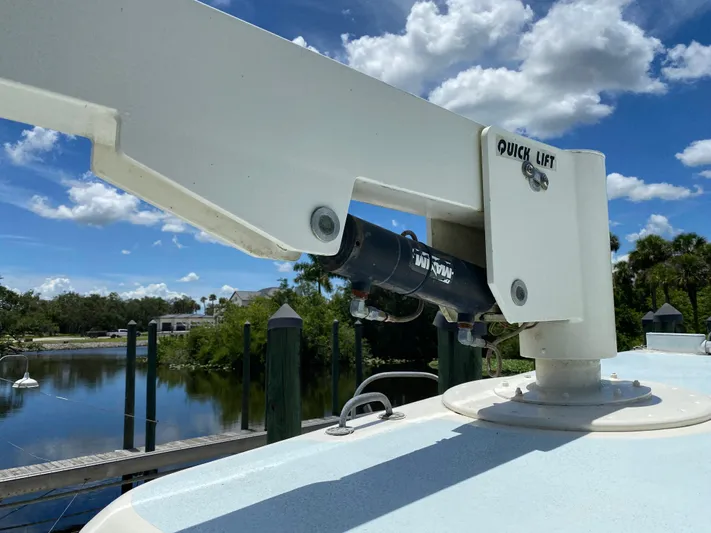 Mirage Yacht Photos Pics Boat crane labeled "Quick Lift" on a Custom 62, 1996 model, with scenic waterway background.