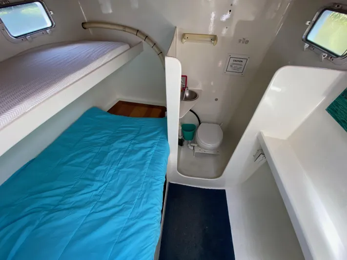 Mirage Yacht Photos Pics Compact boat cabin interior with bunk beds and small bathroom, Custom 62 model, 1996.