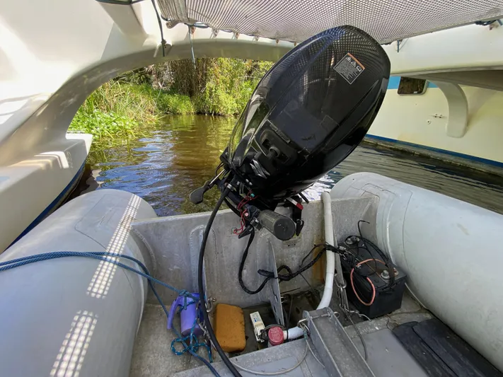 Mirage Yacht Photos Pics Inflatable boat with outboard motor, Custom 62 model, 1996, on a calm river.