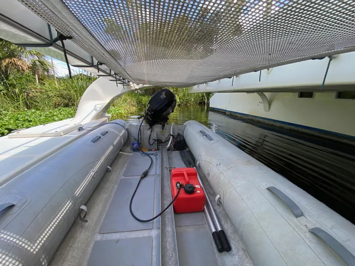 Mirage Yacht Photos Pics Inflatable boat with motor and fuel tank under mesh canopy, Custom 62, 1996 model.