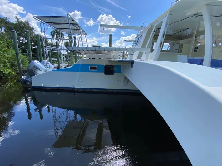 Mirage Yacht Photos Pics Custom 1996 model 62 boat docked on a sunny day with clear skies.