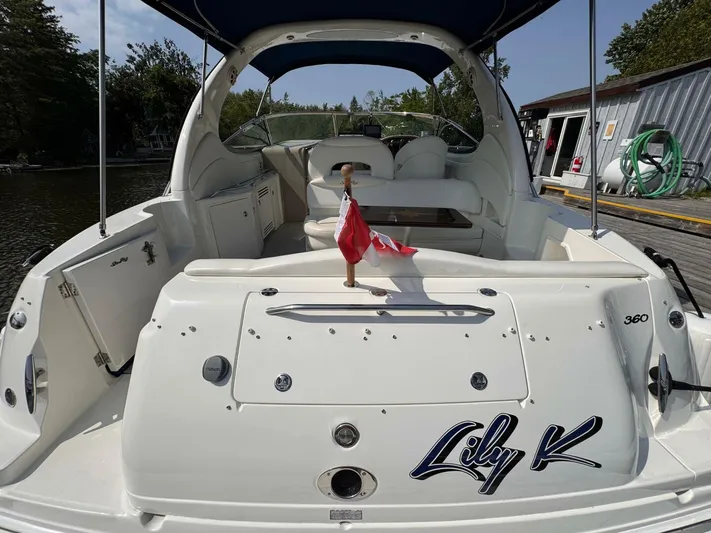  Yacht Photos Pics 2002 Sea Ray 360 Sundancer boat docked, featuring spacious deck and Canadian flag.
