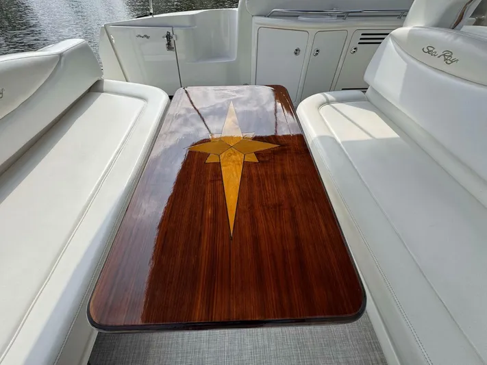  Yacht Photos Pics Luxurious 2002 Sea Ray 360 Sundancer interior with polished wooden table and white seating.