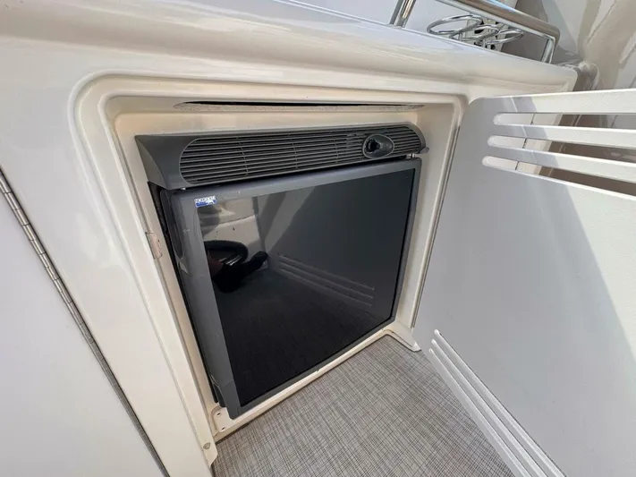  Yacht Photos Pics Mini fridge on 2002 Sea Ray 360 Sundancer yacht, open cabinet view.