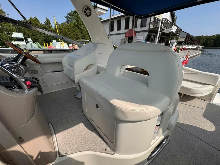  Yacht Photos Pics 2002 Sea Ray 360 Sundancer boat interior with white seating and steering wheel.