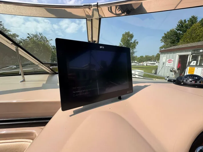  Yacht Photos Pics Dashboard of 2002 Sea Ray 360 Sundancer with monitor and compass, sunny day.